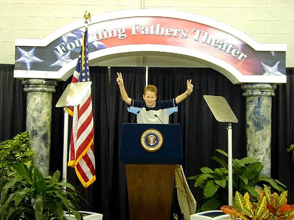 boy at presidential podium